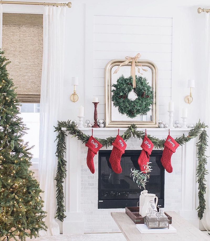 The mirror in this room not only reflects the brilliant tree across the room but also enlarges the preserved boxwood wreath that is suspended from it with a pale yellow silk ribbon. The bird of paradise plant's pitcher is encircled with the same gold lights that is weaved throughout the Christmas tree. Boxwood that has been preserved gives the appearance of fresh foliage, but because it is coated in glycerin, it lasts and looks new for a number of years.