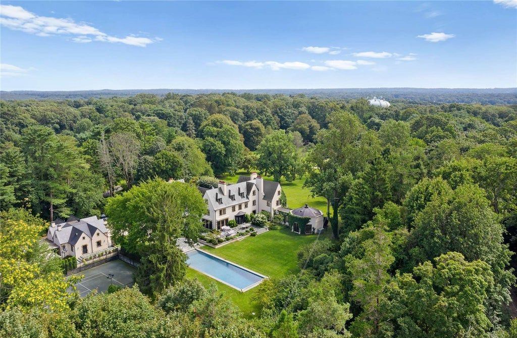 339 Duck Pond Road, Locust Valley, New York is a one of a kind home originally built in 1926 in the prestigious Village of Matinecock with exceptional amenities including a pool, pool house, tennis court, outdoor kitchen, gardens and terraces. elevator, nest system, 3,000 bottle wine cellar, art studio and more.