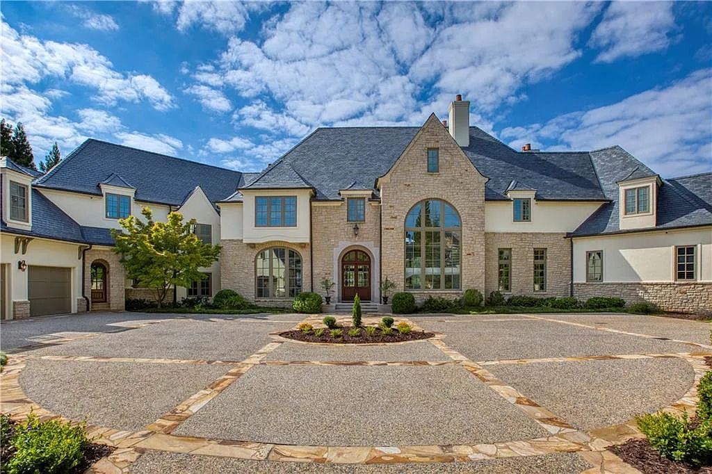 The Home in Alpharetta features a slate roof, copper gutters, a gourmet kitchen, two primary suites, an outdoor kitchen, pool and so much more, now available for sale. This home located at 1220 Troon Ct, Alpharetta, Georgia