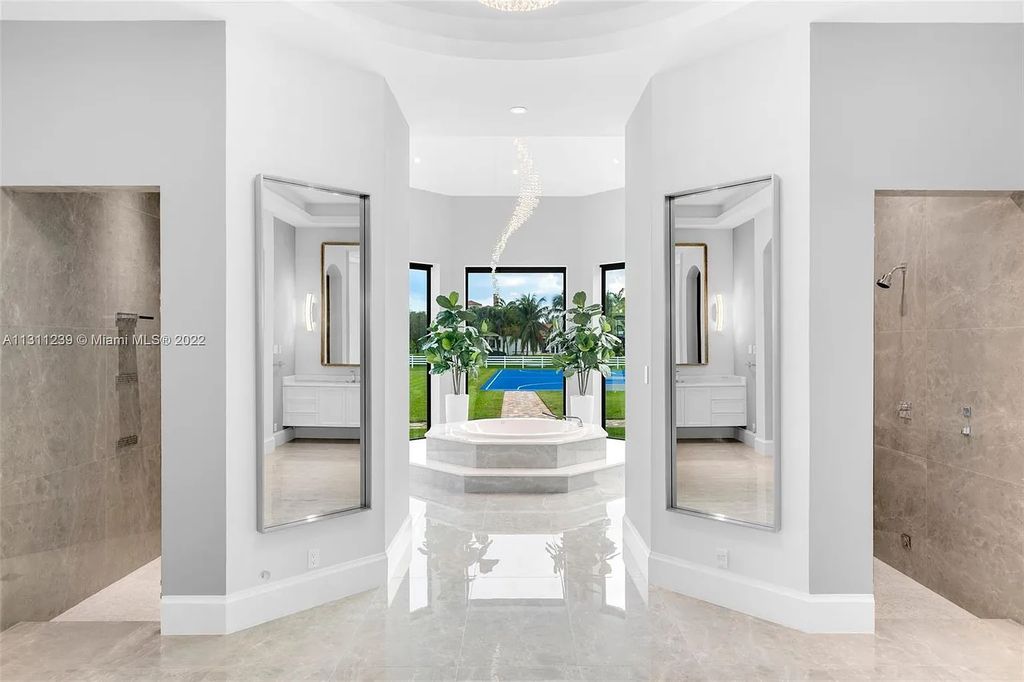 5875 Stone Creek Way, Fort Lauderdale, Florida, built by acclaimed builder Rick Bell, sits on 5 acres and boasts over 20,000 square feet of space. This incredible and one-of-a-kind custom compound's grand estate, including private gates, features volume ceilings, a resort-style pool, and top-of-the-line appliances.