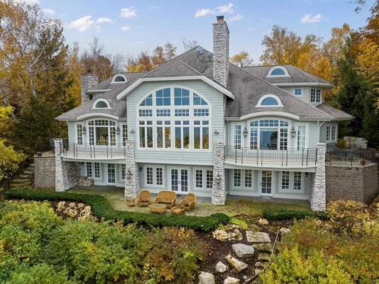 Sitting on a Perfectly Landscaped Lot with Breathtaking Views of Lake, This Sprawling Home in Bay Harbor, MI Sales for $3,499,500