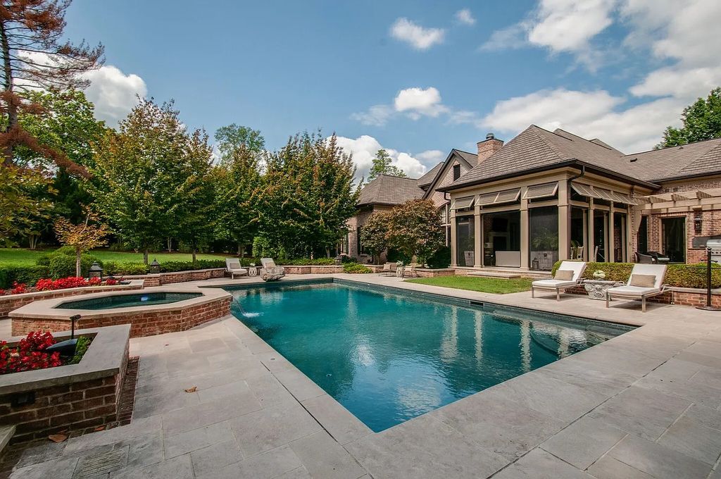 The Estate in Nashville is a luxurious home featuring stunning pool and spa, beautiful landscaping and outdoor kitchen now available for sale. This home located at 34 Lynnwood Ln, Nashville, Tennessee; offering 05 bedrooms and 08 bathrooms with 6,373 square feet of living spaces. 