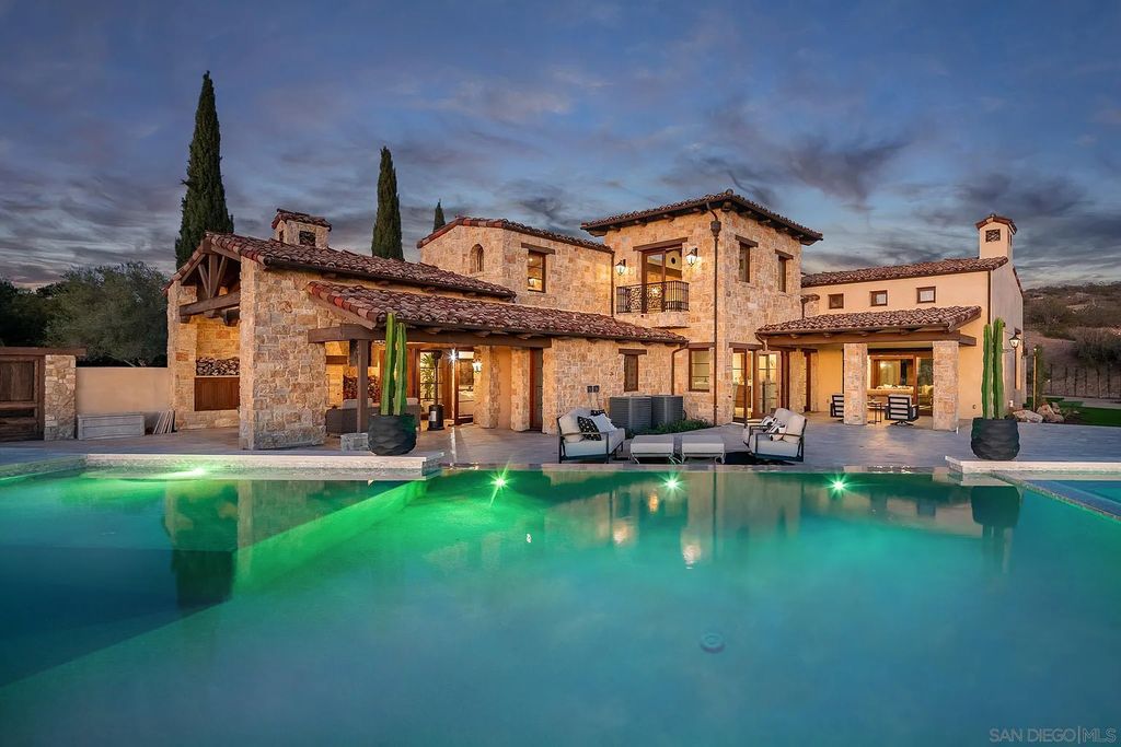 8069 Entrada De Luz East, San Diego, California is an exquisite estate located on in one of the most exclusive, gated golf communities in San Diego, boasts total privacy, large living areas, open through disappearing doors to multiple covered patios.