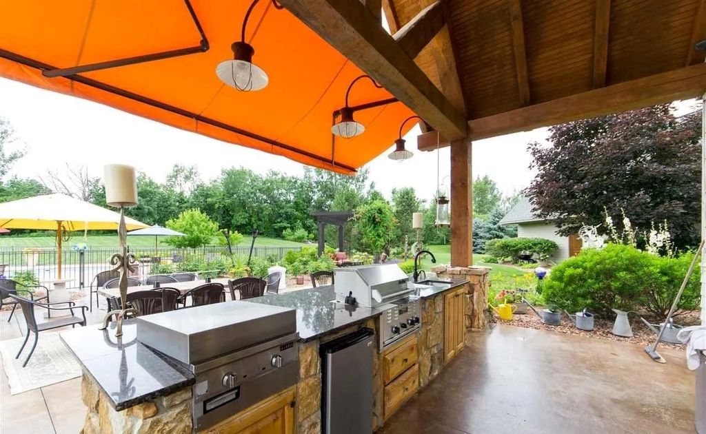 The House in Traverse City is the perfect place to entertain family and friends, featuring: a full outdoor kitchen, warm cozy fireplace and a large heated pool, now available for sale. This home located at 7799 Underwood Rdg, Traverse City, Michigan