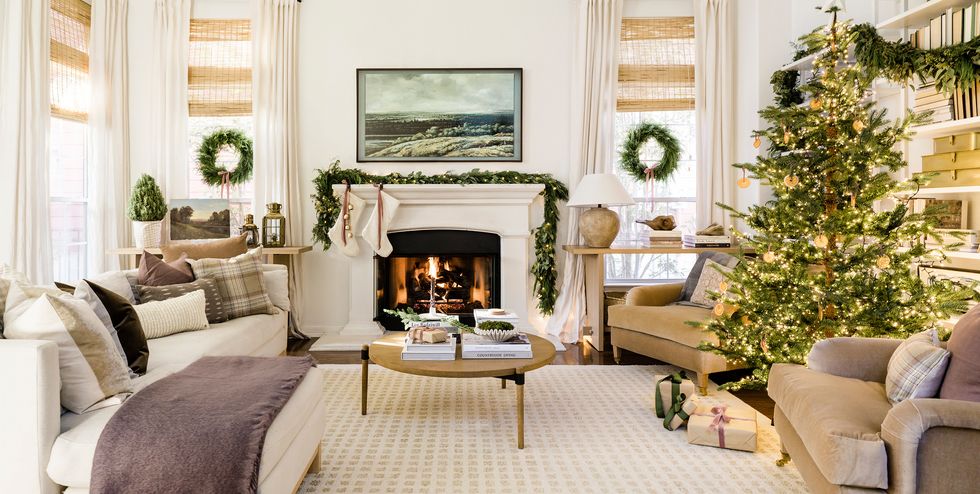 You can still create a festive space without over-the-top Christmas bling. This house with views of ancient live oak trees, so homeowner chose to bring the outside in with unadorned greenery for a more seamless experience. Fragrant cedar garlands frame the living room's stunning architecture punching up this neutral living room with the traditional green of the holidays.