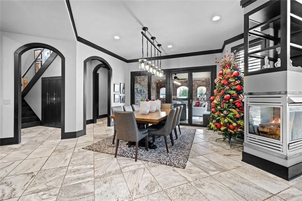 62 W Buckingham Drive, Rogers, Arkansas is a lavishly appointed contemporary home in Pinnacle Country Club with amazing amenities including a custom designed kitchen with multiple islands, wine cellar, private office, home theater, exercise room, and a library loft. 