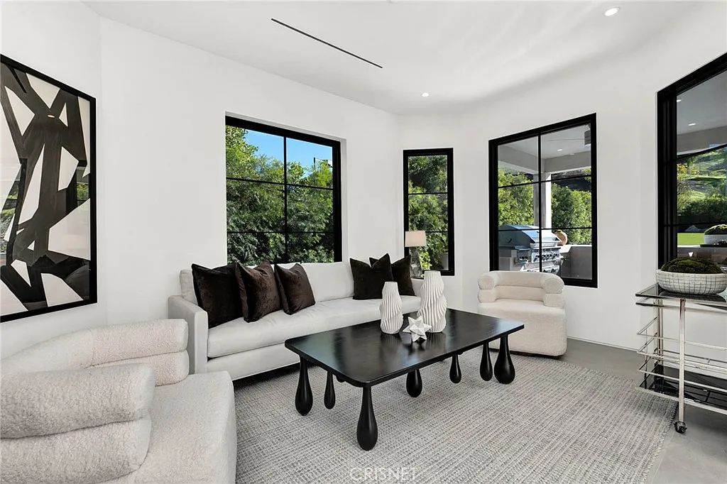 20620 Chatsboro Drive, Woodland Hills, California is an impeccably remodeled Smart home in the guard-gated Westchester County Estates community with gorgeous flooring and crisp white tones are bathed in abundant sunlight by multiple large windows with contrasting black trim.
