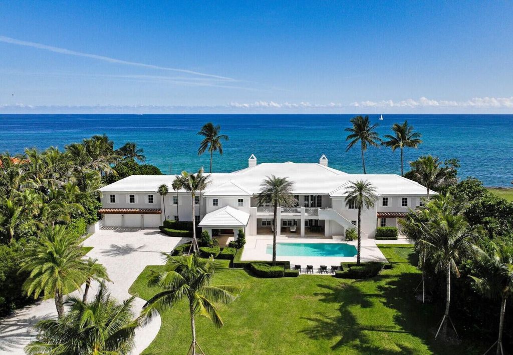 1120 S Ocean Boulevard, Manalapan, Florida is a beautiful beachfront estate stretches an impressive 193' of water frontage across each of the beach and lake coastlines and is equipped with a private dock that can support vessels up to 40' and a brand new seawall.