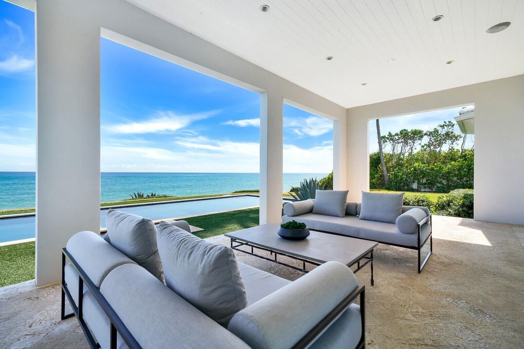 1120 S Ocean Boulevard, Manalapan, Florida is a beautiful beachfront estate stretches an impressive 193' of water frontage across each of the beach and lake coastlines and is equipped with a private dock that can support vessels up to 40' and a brand new seawall.