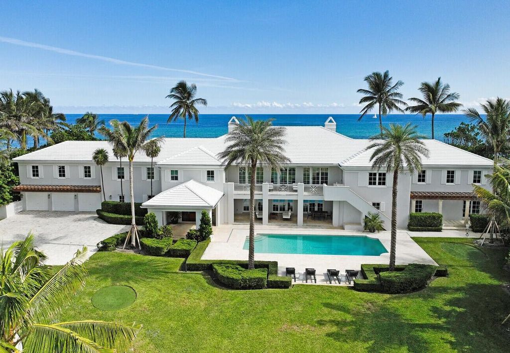 1120 S Ocean Boulevard, Manalapan, Florida is a beautiful beachfront estate stretches an impressive 193' of water frontage across each of the beach and lake coastlines and is equipped with a private dock that can support vessels up to 40' and a brand new seawall.