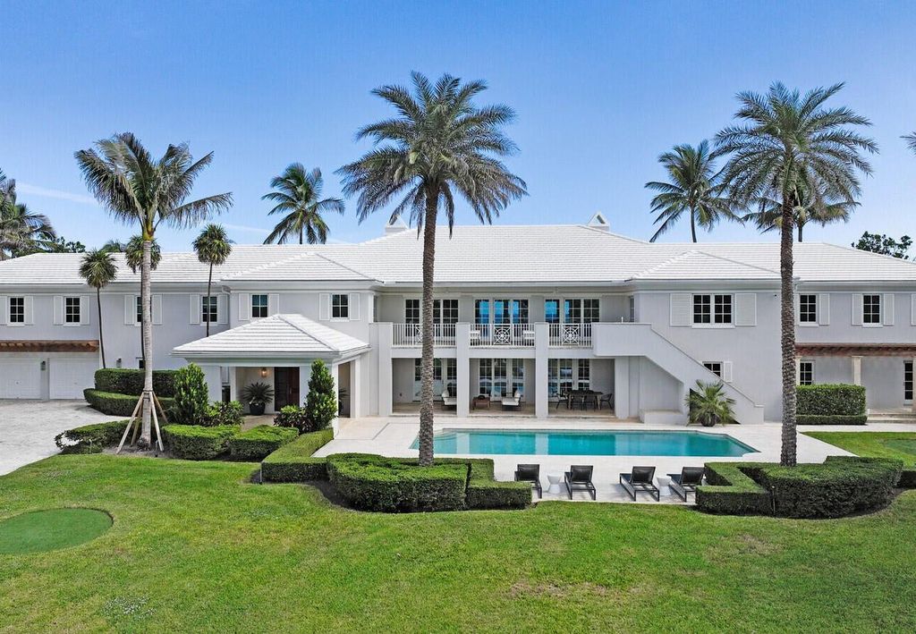 1120 S Ocean Boulevard, Manalapan, Florida is a beautiful beachfront estate stretches an impressive 193' of water frontage across each of the beach and lake coastlines and is equipped with a private dock that can support vessels up to 40' and a brand new seawall.