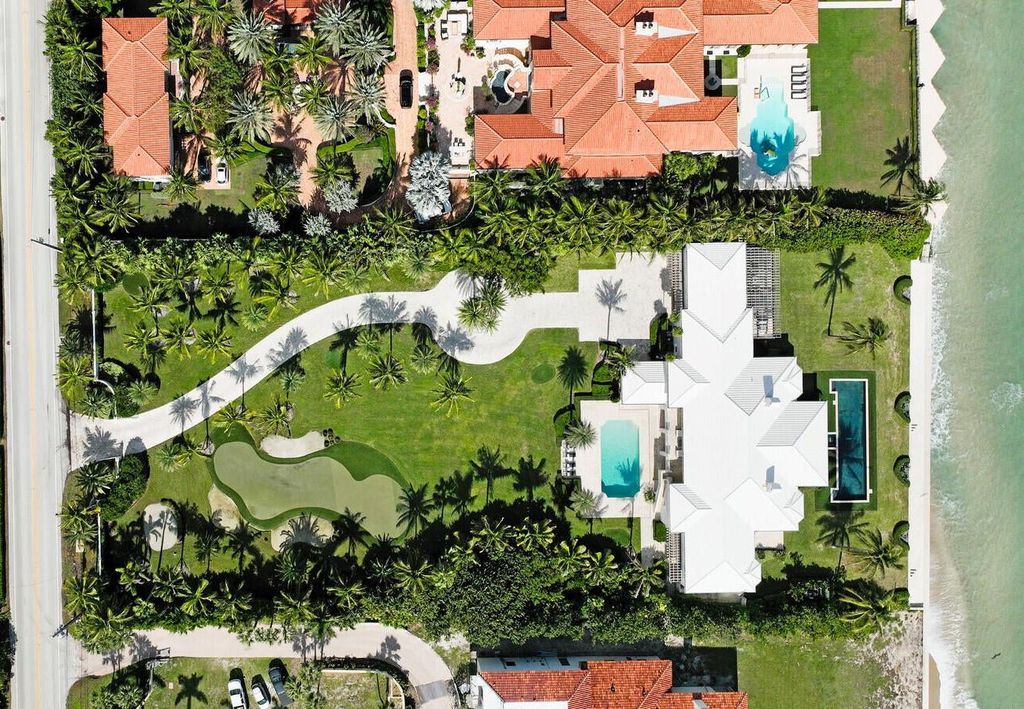 1120 S Ocean Boulevard, Manalapan, Florida is a beautiful beachfront estate stretches an impressive 193' of water frontage across each of the beach and lake coastlines and is equipped with a private dock that can support vessels up to 40' and a brand new seawall.