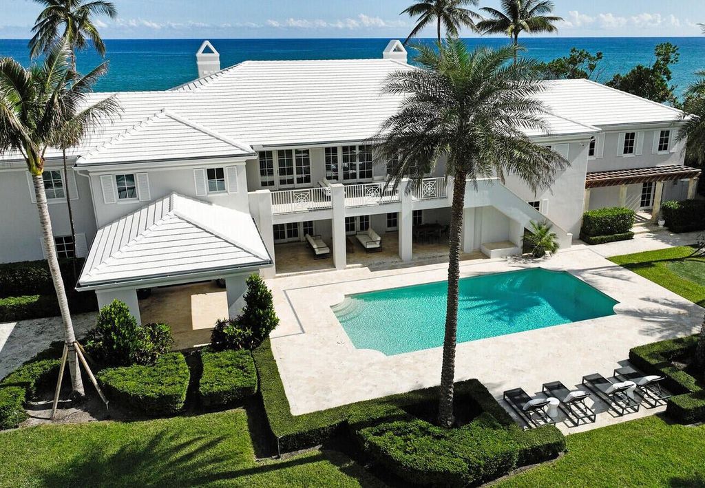 1120 S Ocean Boulevard, Manalapan, Florida is a beautiful beachfront estate stretches an impressive 193' of water frontage across each of the beach and lake coastlines and is equipped with a private dock that can support vessels up to 40' and a brand new seawall.