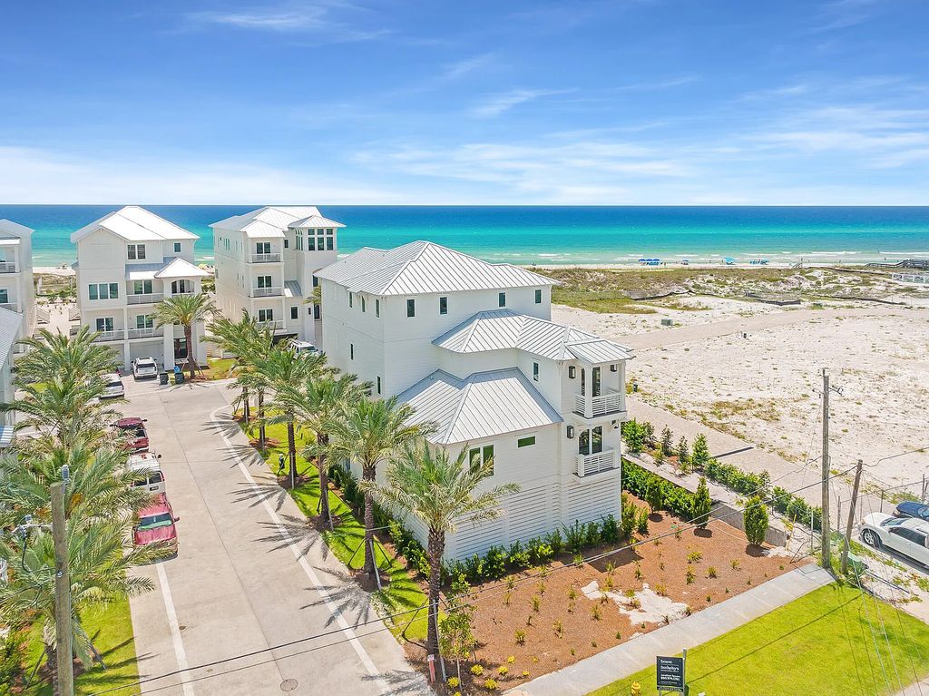 26 Palm Court Lane, Inlet Beach, Florida is an exceptional home boasts Notable architectural elements paired with lush landscaping & foliage provide a beautiful sense of arrival while optimal conveniences such as a private elevator accessing all floors create unmatched functionality.