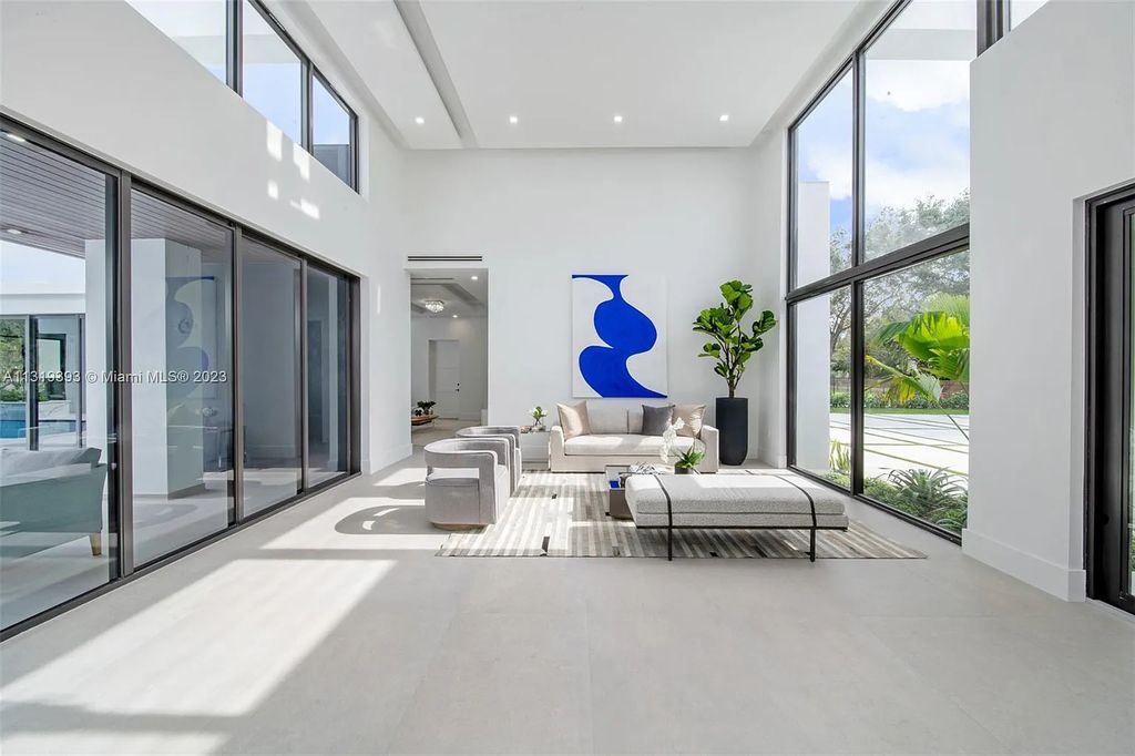 9765 SW 110th Street, Miami, Florida is an exquisite modern new construction built among stately palms and mature oak trees on a quiet cul-de-sac, experience the ultimate South Florida lifestyle lounging around the 38' pool with spa and 3 beaches.