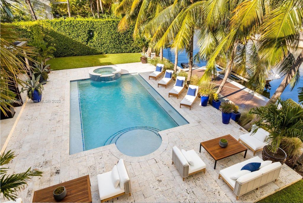 2901 Flamingo Drive, Miami Beach, Florida is named La Joya with 300 foot of water in most vibrant neighborhood on Miami Beach, features include dramatic master + sitting rm. 13ft ceilings, wall of glass, + 3 terraces. 4 beds up 1 down+ office/library. 1 bd, 1 and a half bath guest villa with private patio, 2 car garage, private gated entry court.