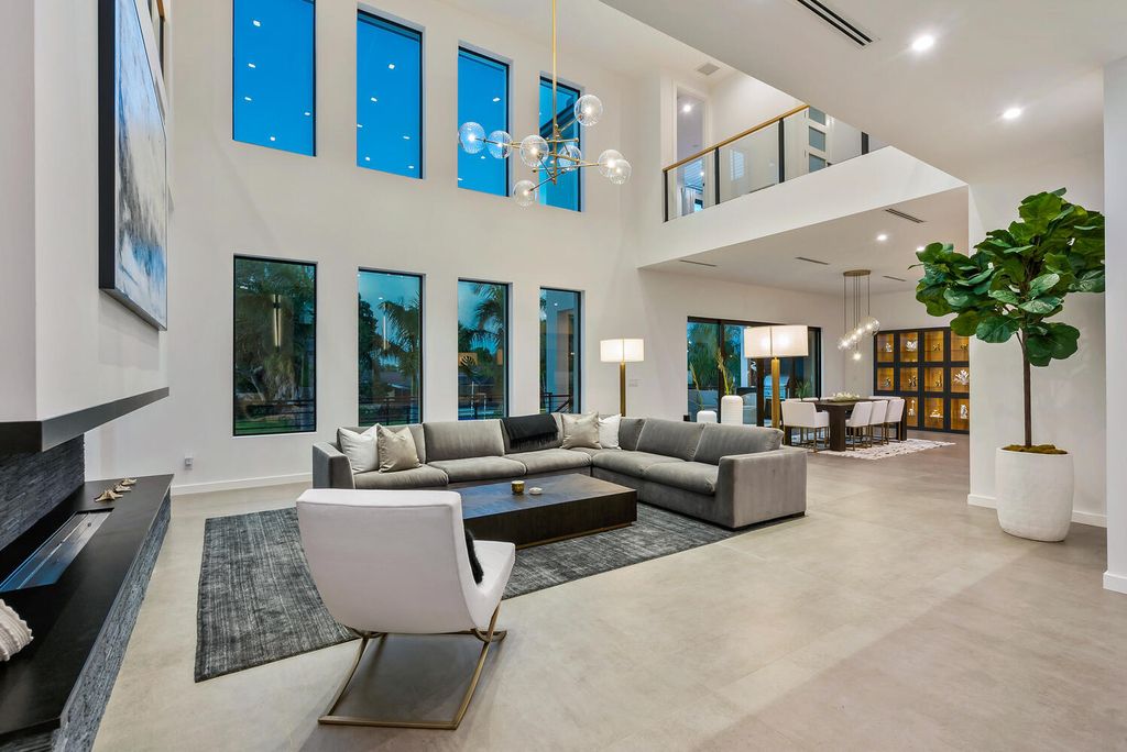 545 Kingfisher Lane, Longboat Key, Florida is a custom built modern canal front Longboat Key home with dramatic wide shell stone stair entrance, massive 60-inch ceramic tile flooring, 20-foot ceilings, skylights, lap-pool with 2 waterfall features, outdoor kitchen adjacent to indoor kitchen, and 5-car garage.