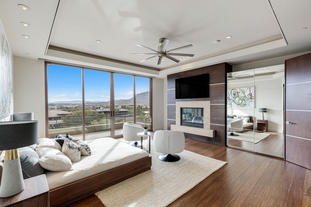 91 Hawk Ridge Drive, Las Vegas, Nevada is An entertainer's dream blends indoor and outdoor spaces with pocket doors that disappear in walls, amenities include Wolf and Miele appliances, wet bar, wine storage and butler's pantry, resort-like backyard, infinity-edge pool, spa, wet deck and fire features. 