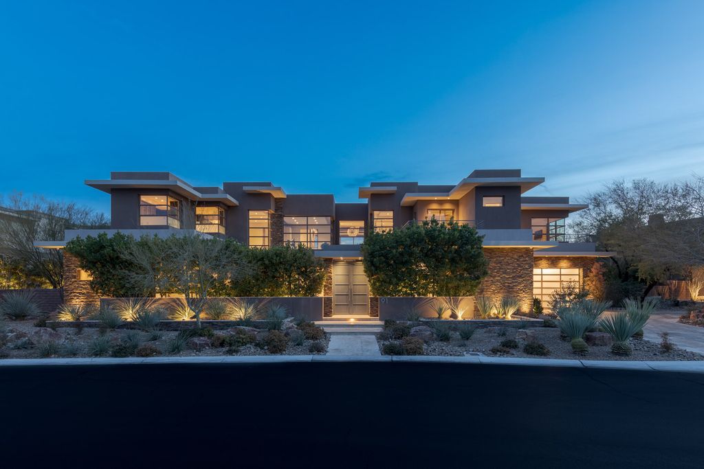91 Hawk Ridge Drive, Las Vegas, Nevada is An entertainer's dream blends indoor and outdoor spaces with pocket doors that disappear in walls, amenities include Wolf and Miele appliances, wet bar, wine storage and butler's pantry, resort-like backyard, infinity-edge pool, spa, wet deck and fire features. 