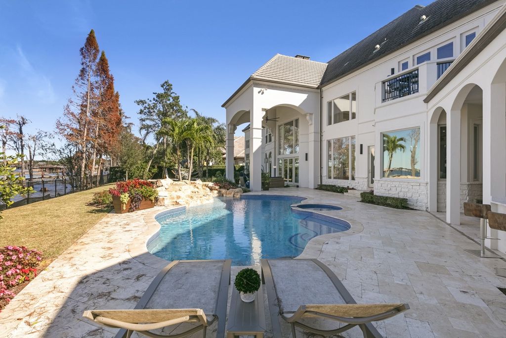 9275 Point Cypress Drive, Orlando, Florida is a luxury property features dual lake frontage between Lake Tibet & Lake Sheen within the guard gated community of Cypress Point in a supremely convenient Butler Chain location. 