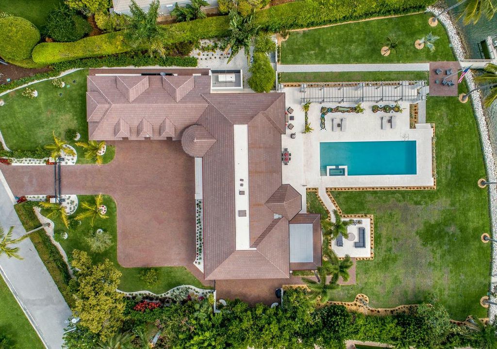 3595 Gin Lane, Naples, Florida is a gated property situated on nearly an acre overlooking Hidden Bay with quick access to the Gulf of Mexico, beautifully renovated and reimagined in 2018 with amenities as a private elevator, cherry wood library, double island in kitchen. 