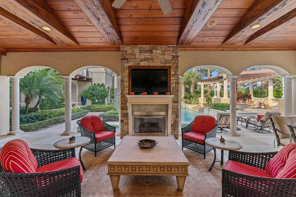 11724 Cardena Court, Palm Beach Gardens, Florida, features a gracious two-story entry with a grand sweeping stairway. It is fantasitic to entertain in spacious paver patios & fountains, as also grand open patios w/heated pool, separate stone spa, travertine pavers, & custom cypress trellis.