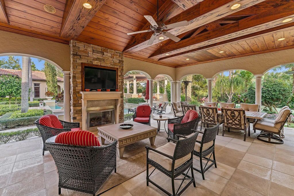 11724 Cardena Court, Palm Beach Gardens, Florida, features a gracious two-story entry with a grand sweeping stairway. It is fantasitic to entertain in spacious paver patios & fountains, as also grand open patios w/heated pool, separate stone spa, travertine pavers, & custom cypress trellis.