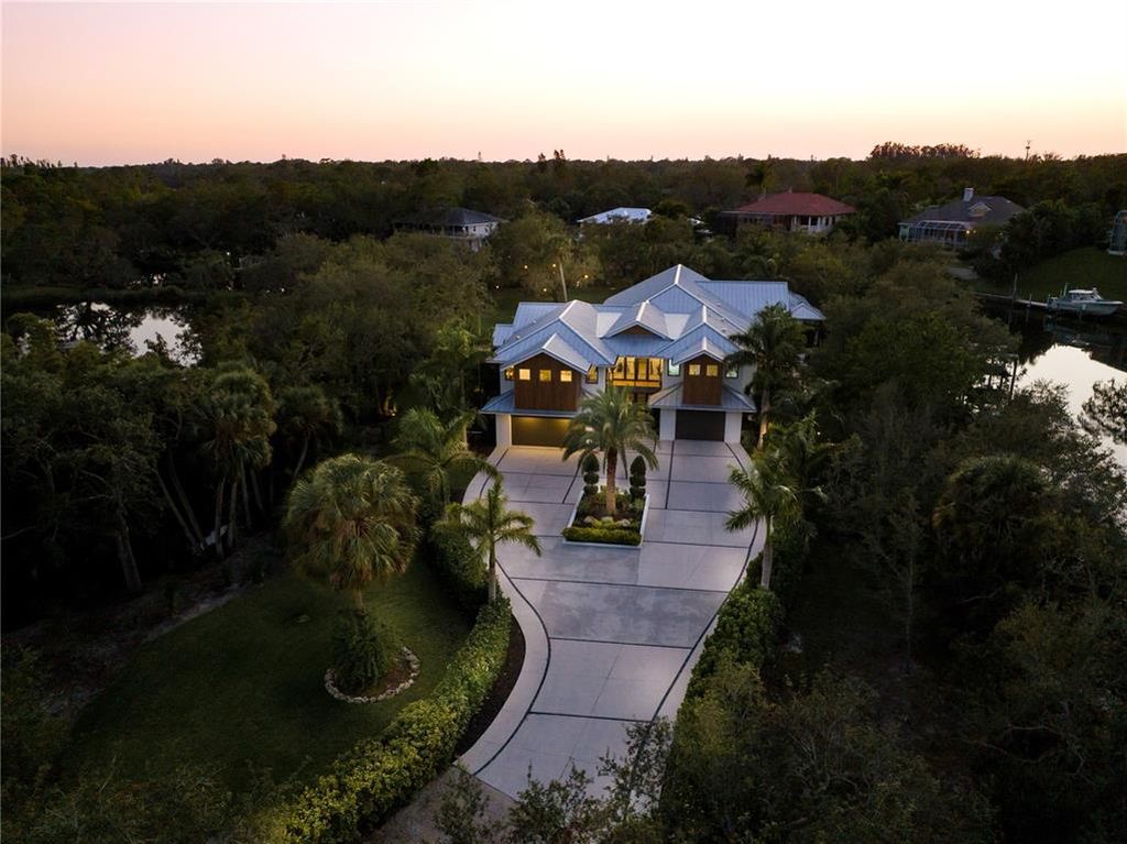 3940 Elysian Woods Lane, Sarasota, Florida is a mature landscaped estate is nestled on 1.47 acres and completely private in a small, gated community with only eight homes, was built with meticulous craftsmanship and bespoke finishes throughout.