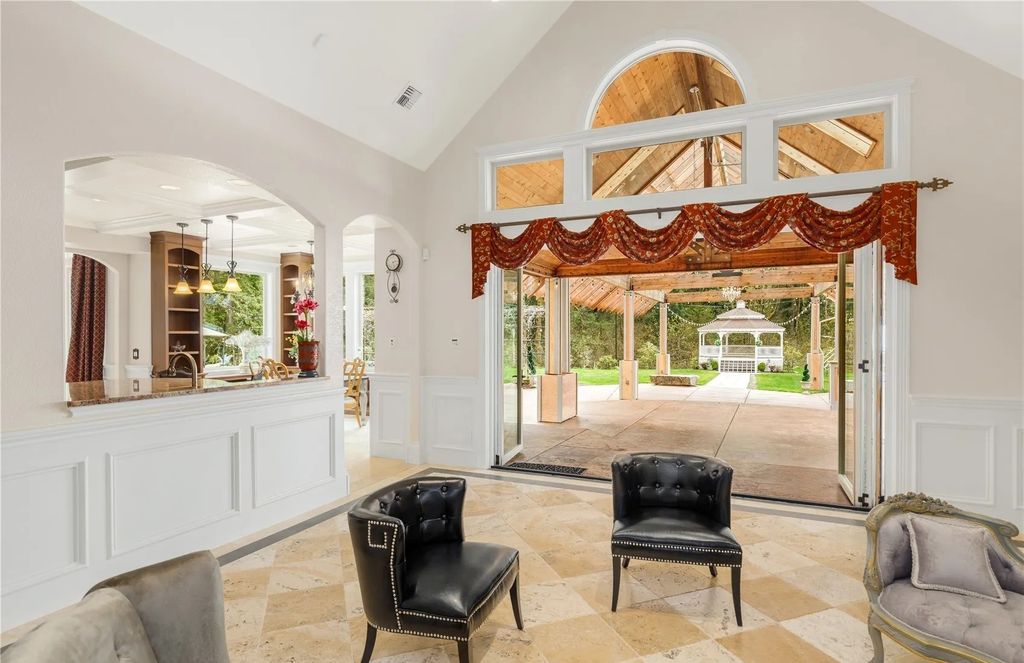 The Estate in Maple Valley boasts striking 22’ ceilings, library, home theater, gym, conference room, and an elevator to all three floors, now available for sale. This home located at 21145 212th Avenue SE, Maple Valley, Washington