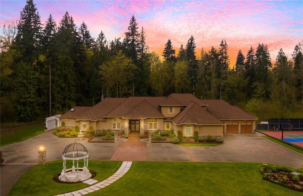 The Estate in Maple Valley boasts striking 22’ ceilings, library, home theater, gym, conference room, and an elevator to all three floors, now available for sale. This home located at 21145 212th Avenue SE, Maple Valley, Washington