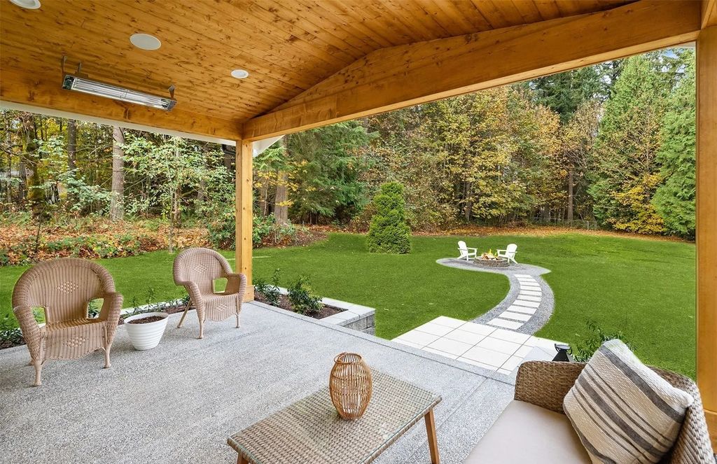 The Home in Woodinville features soaring sun-drenched living spaces with rich hardwood floors and walls of windows, now available for sale. This home located at 16706 NE 179th Street, Woodinville, Washington
