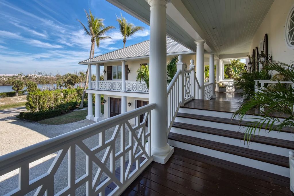 16440 Gulf Shores Drive, Boca Grande, Florida is a breathtaking home sit on unparalleled location offering privacy and luxurious coastal living with lush tropical landscaping and inviting outdoor spaces, boasting incredible views of the Gulf on one side and Lake Gasparilla on the other.