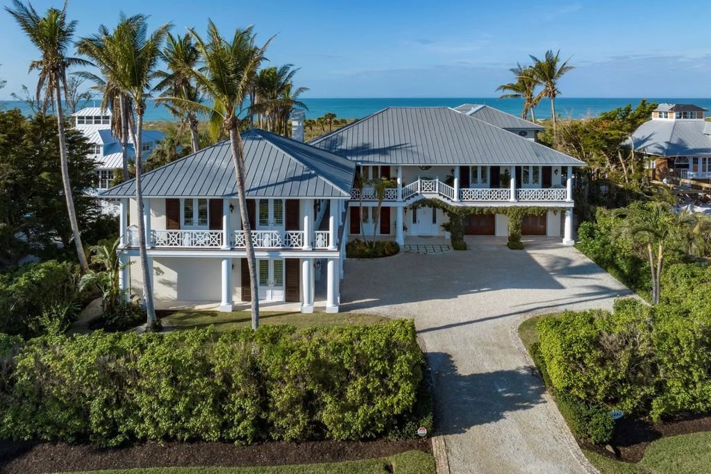 16440 Gulf Shores Drive, Boca Grande, Florida is a breathtaking home sit on unparalleled location offering privacy and luxurious coastal living with lush tropical landscaping and inviting outdoor spaces, boasting incredible views of the Gulf on one side and Lake Gasparilla on the other.
