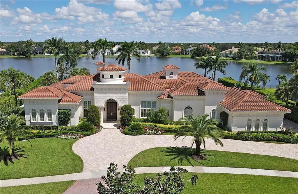 13741 Pondview Circle, Naples, Florida, lords almost an acre of land and offers over 6700 sq ft of living space and luxurious upgrades throughout. This majestic lakefront estate in Quail West is move-in ready with new furnishings and is a showcase of timeless elegance.