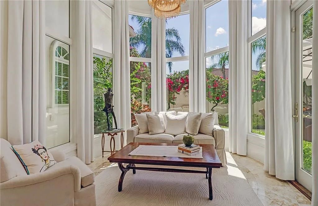 13741 Pondview Circle, Naples, Florida, lords almost an acre of land and offers over 6700 sq ft of living space and luxurious upgrades throughout. This majestic lakefront estate in Quail West is move-in ready with new furnishings and is a showcase of timeless elegance.