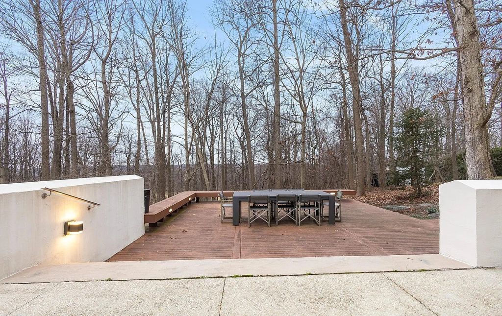 The House in Owings Mill features magnificent wooded views of the 2+ acre site plus 33 or more acres of open space in the valley beyond, now available for sale. This home located at 1 Huntersworth Ct, Owings Mills, Maryland