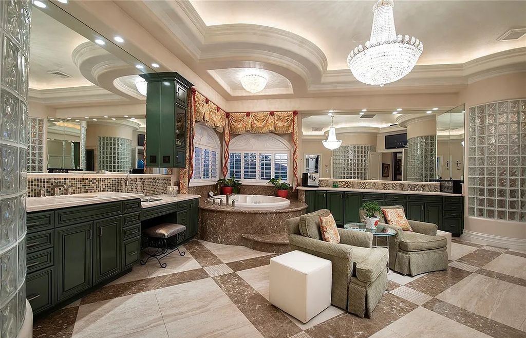 8920 Players Club Drive, Las Vegas, Nevada is a sprawling estate designed for entertaining on a grand scale with soaring ceiling heights, expansive entry, and ornate marble and carpet floor patterns.