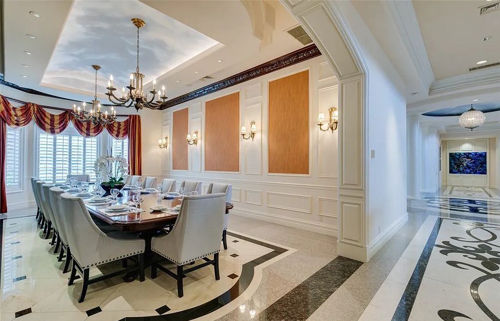 8920 Players Club Drive, Las Vegas, Nevada is a sprawling estate designed for entertaining on a grand scale with soaring ceiling heights, expansive entry, and ornate marble and carpet floor patterns.