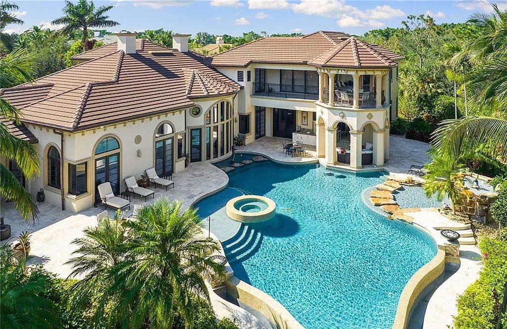 2531 Escada Court, Naples, Florida perfectly positioned on a cul-de-sac within the renowned Escada Estates. This exceptional estate overlooks the 15th hole of Tiburón Golf Club at Ritz-Carlton Golf Resort, where residents enjoy access to member privileges.