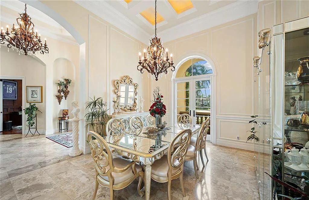2531 Escada Court, Naples, Florida perfectly positioned on a cul-de-sac within the renowned Escada Estates. This exceptional estate overlooks the 15th hole of Tiburón Golf Club at Ritz-Carlton Golf Resort, where residents enjoy access to member privileges.