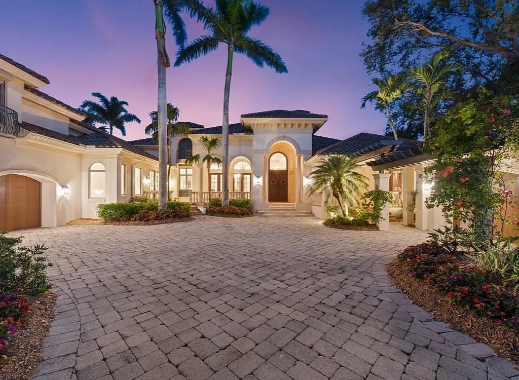26079 Fawnwood Court, Bonita Springs, Florida, is a beautiful lakefront home built on a prominent corner lot in desirable Spring Ridge. With warm and inviting décor and a separate waterfall flowing into a tropical lagoon pool, it is a timeless design.