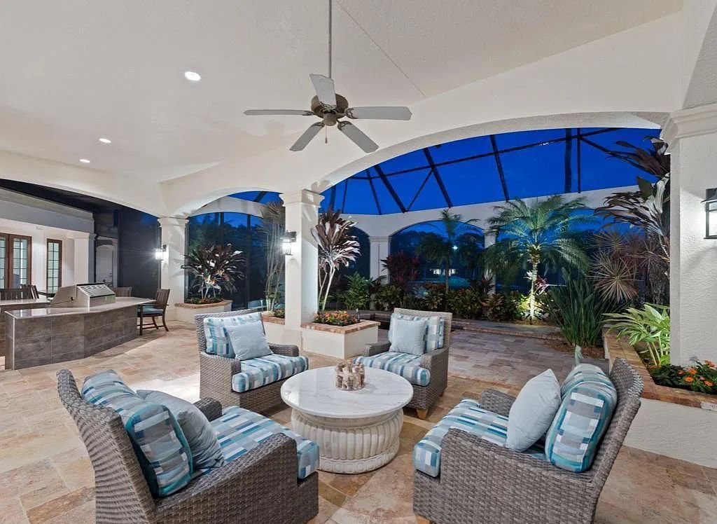 26079 Fawnwood Court, Bonita Springs, Florida, is a beautiful lakefront home built on a prominent corner lot in desirable Spring Ridge. With warm and inviting décor and a separate waterfall flowing into a tropical lagoon pool, it is a timeless design.