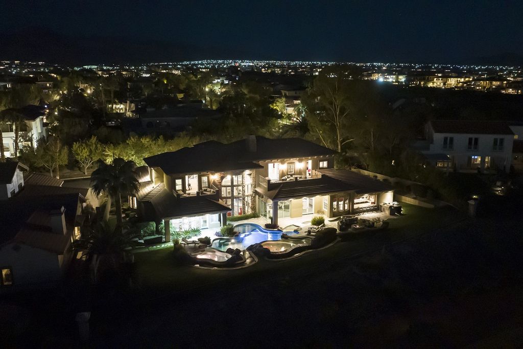1513 Villa Rica Drive, Henderson, Nevada is a chic home in the Estates in Seven Hills with resort amenities including indoor-outdoor bar, movie theater, smart home, entertainers kitchen, bar seating, chic mirrored backsplash and more.