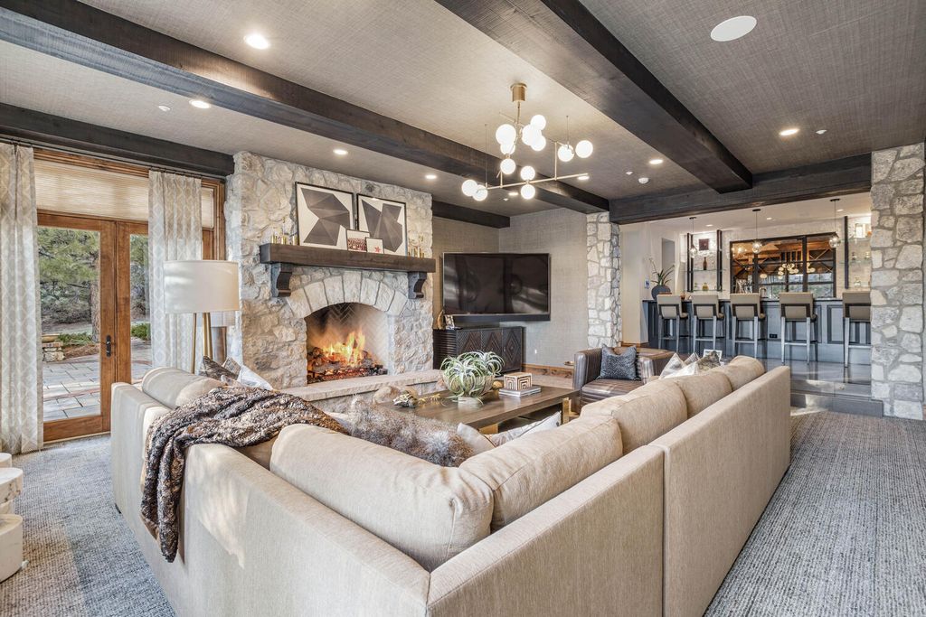 4 Eagle Pointe Lane, Castle Rock, Colorado is a a stunning renovation of a 2003 Trillium Home with the sweeping layout, along with dramatic wall and ceiling treatments, immaculate wood features, multiple fireplaces, and high-end designer finishes.