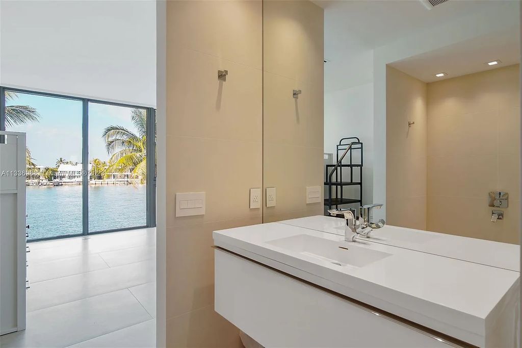 305 N Shore Drive, Miami Beach, Florida, is located in the secure, gated community of Normandy Shores, with 24-hour security. It features luxurious finishes and energy-efficient solar panels.