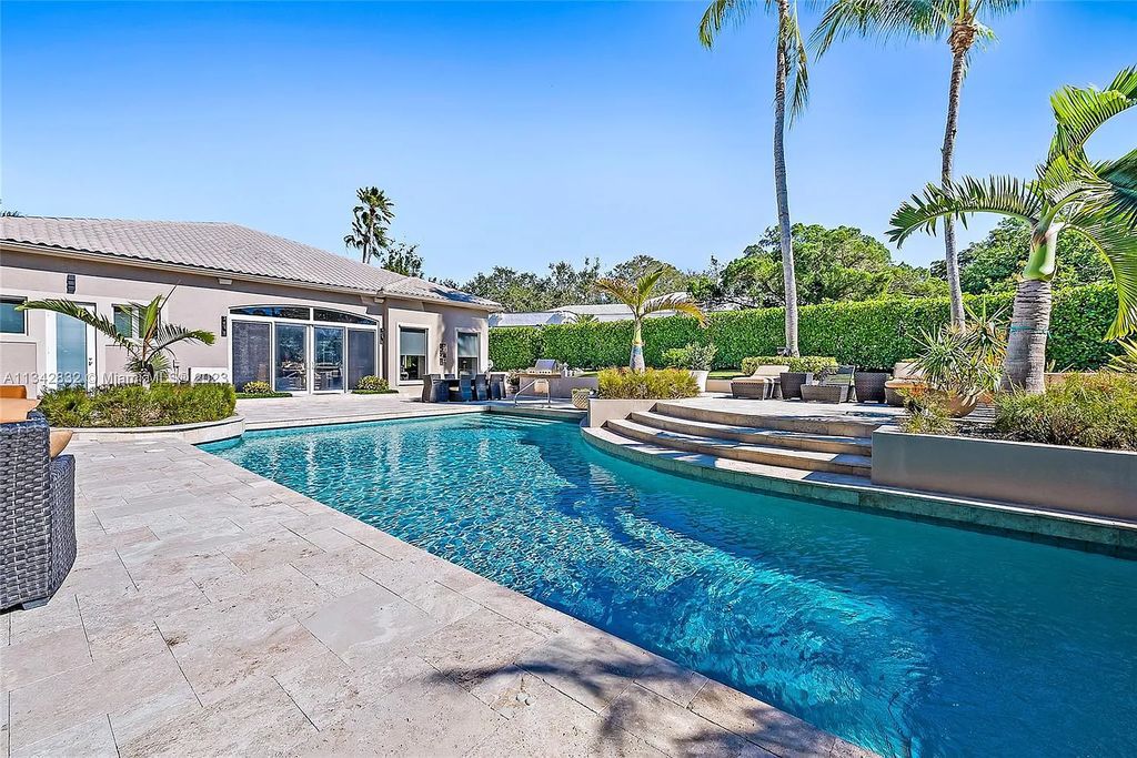 337 Eagle Drive, Jupiter, Florida, is like a jewel box with luxurious furnishings and private outdoor living space. It is perfect to have entertaining in family room with open kitchen and expansive views of the pool.