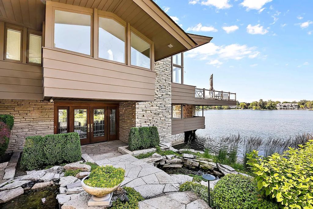 The Property in Park Ridge boasts a 140 feet water front with a sandy beach, has two waterfalls, a tranquil pond, stone sea wall and walkway, now available for sale. This home located at 130 N Dee Rd, Park Ridge, Illinois