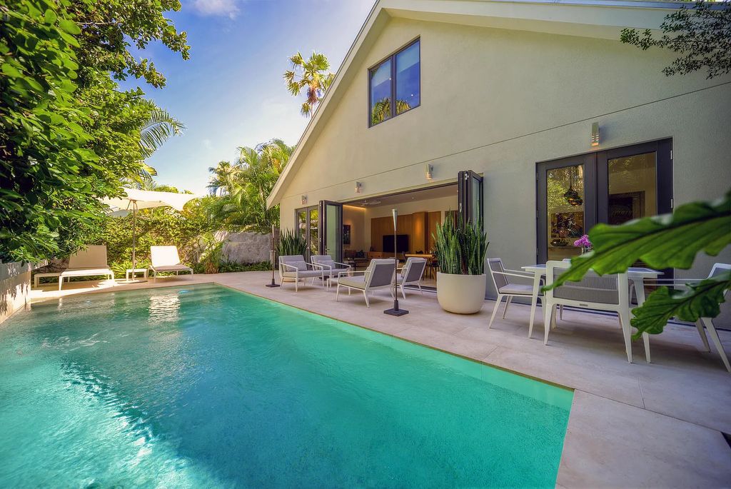 1025 Von Phister Street, Key West, Florida, is located in a sought-after neighborhood offering a tranquil escape. Both in the front and back yards, it is surrounded by lush tropical gardens.