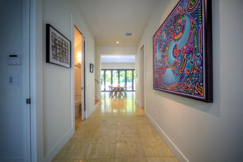 1025 Von Phister Street, Key West, Florida, is located in a sought-after neighborhood offering a tranquil escape. Both in the front and back yards, it is surrounded by lush tropical gardens.