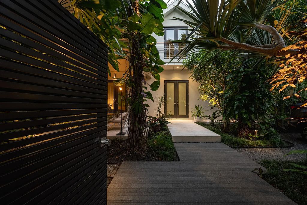 1025 Von Phister Street, Key West, Florida, is located in a sought-after neighborhood offering a tranquil escape. Both in the front and back yards, it is surrounded by lush tropical gardens.